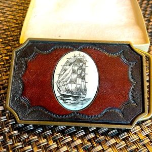 A Barlow brass belt buckle with ship engraved on simulated ivory.
